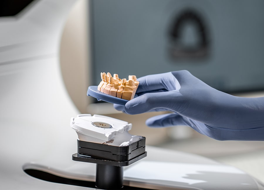 A dentist holds an X-ray up to the light for a better look.